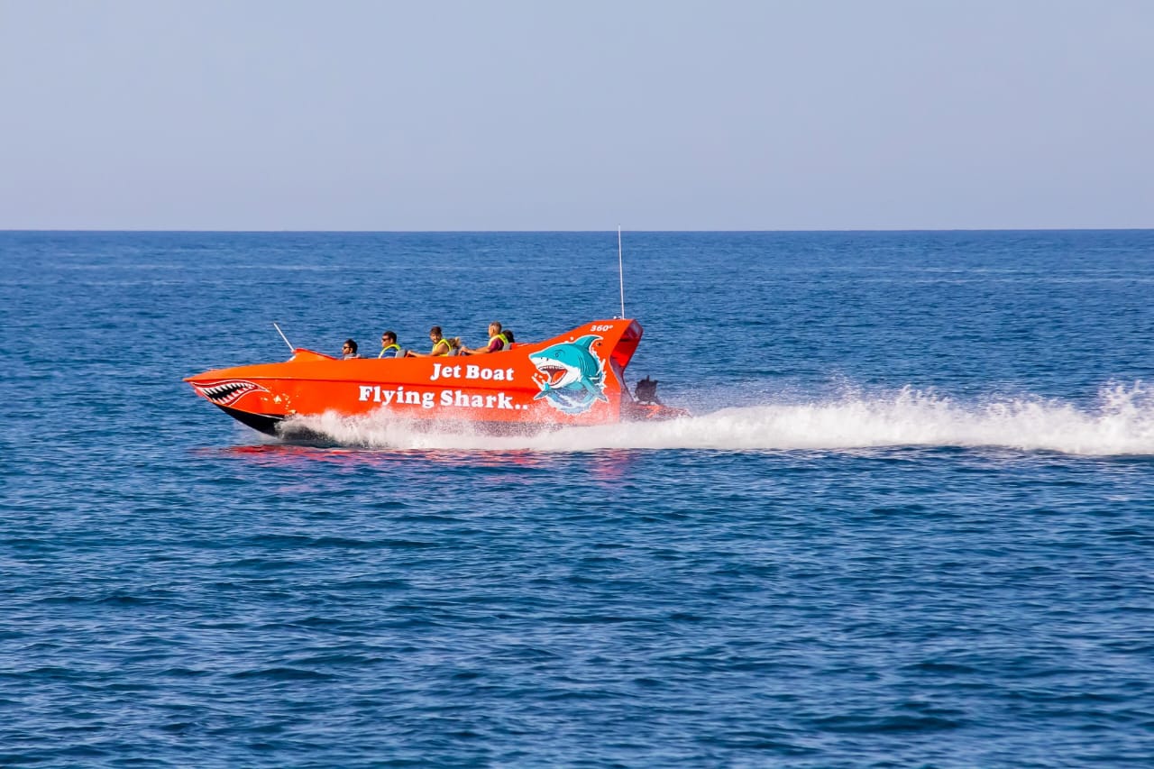 Jet boat excursion speeding past beaches and seaside vistas